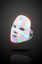 LED face mask with colorful lights on a dark background