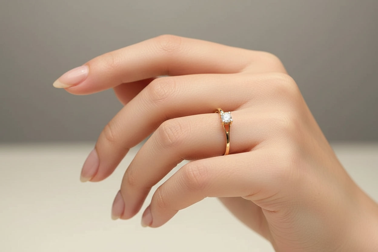 Gold ring with a diamond on a reflective surface