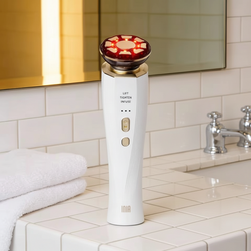 White electronic device with red top on a bathroom counter