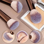 Makeup brushes with purple and beige bristles on a reflective surface.