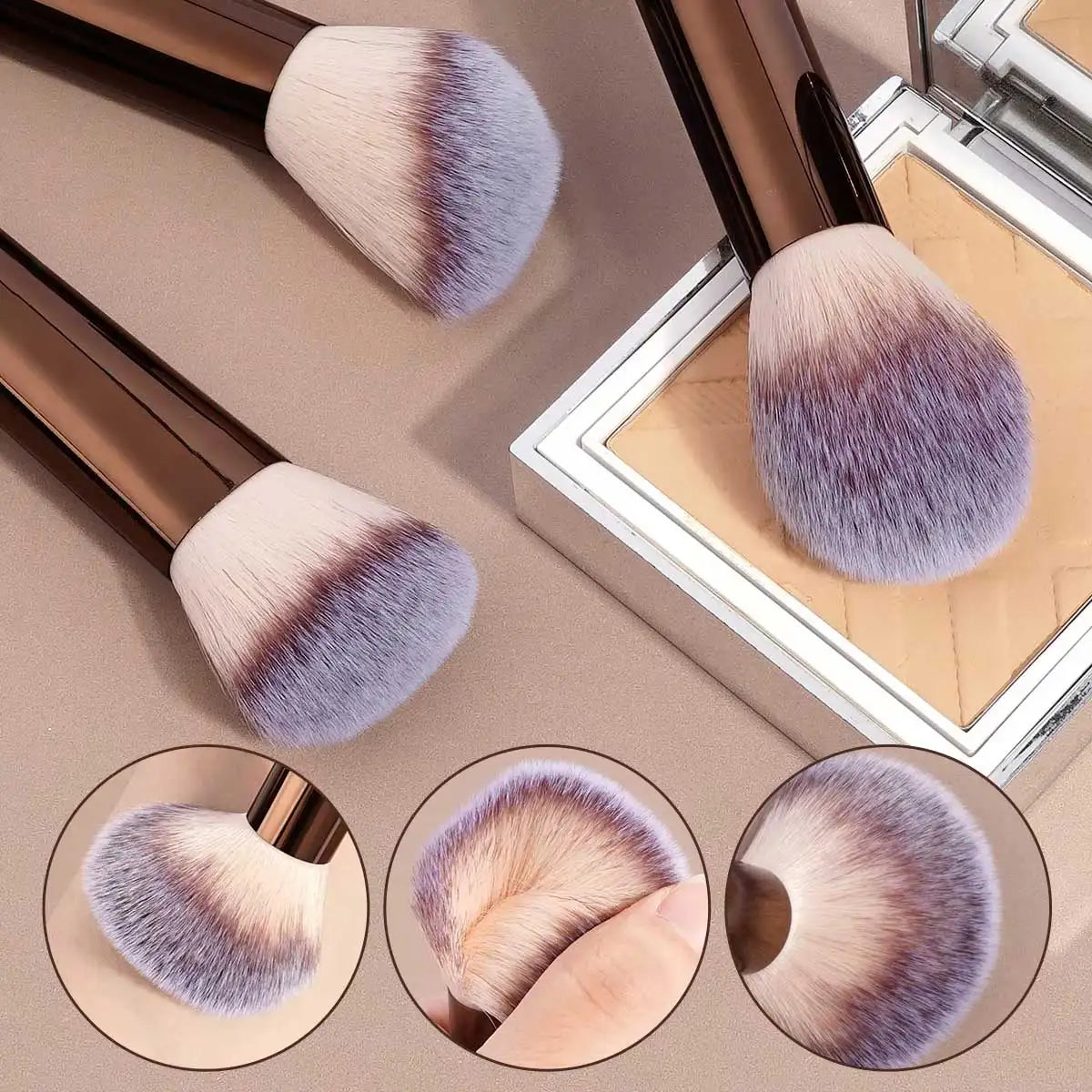 Makeup brushes with purple and beige bristles on a reflective surface.