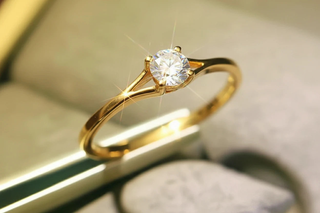 Gold ring with a diamond on a reflective surface