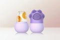 Purple silicone scrubber with textured top and plain bottom on a white background