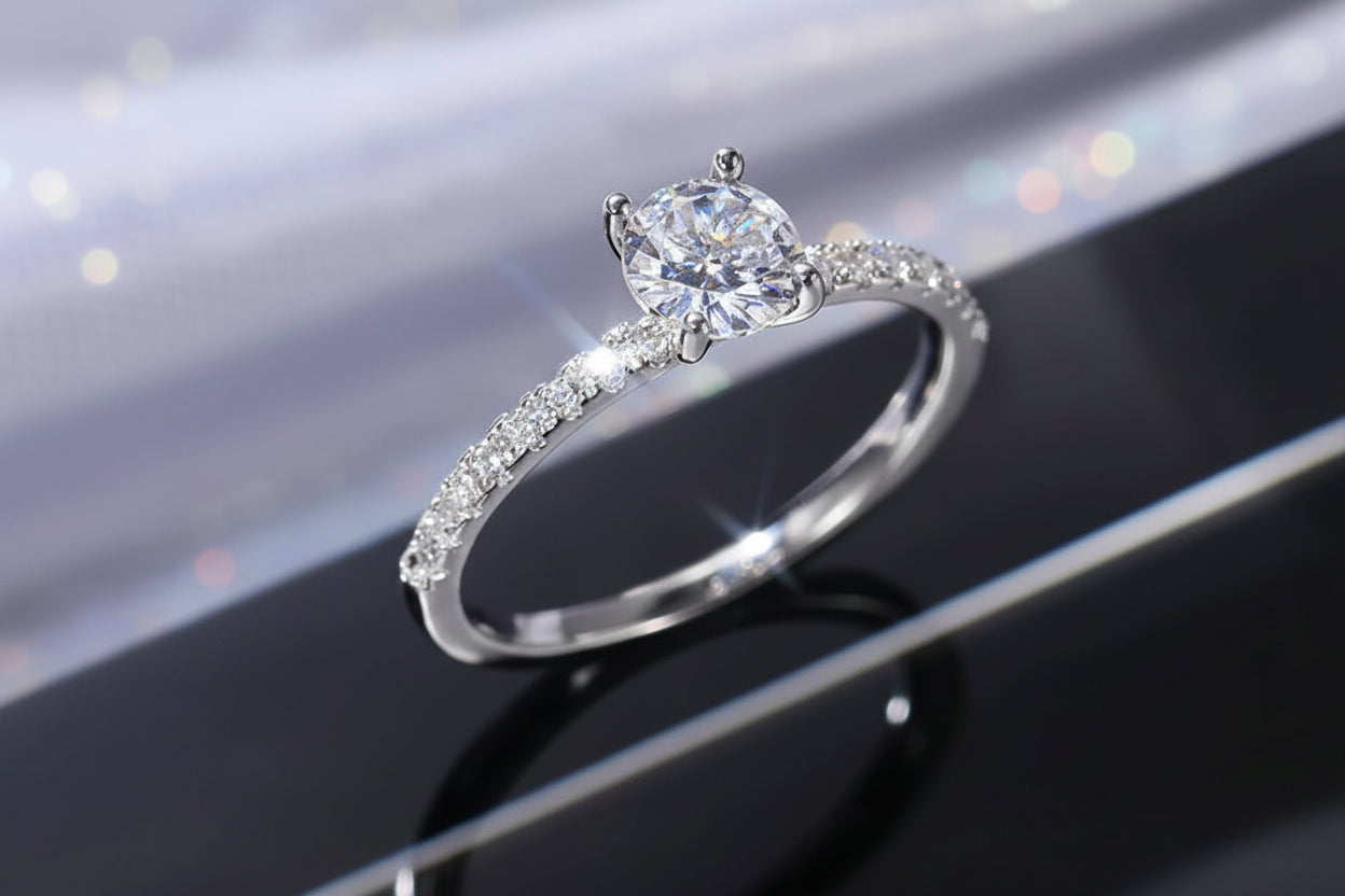 Silver ring with a large diamond on a reflective surface