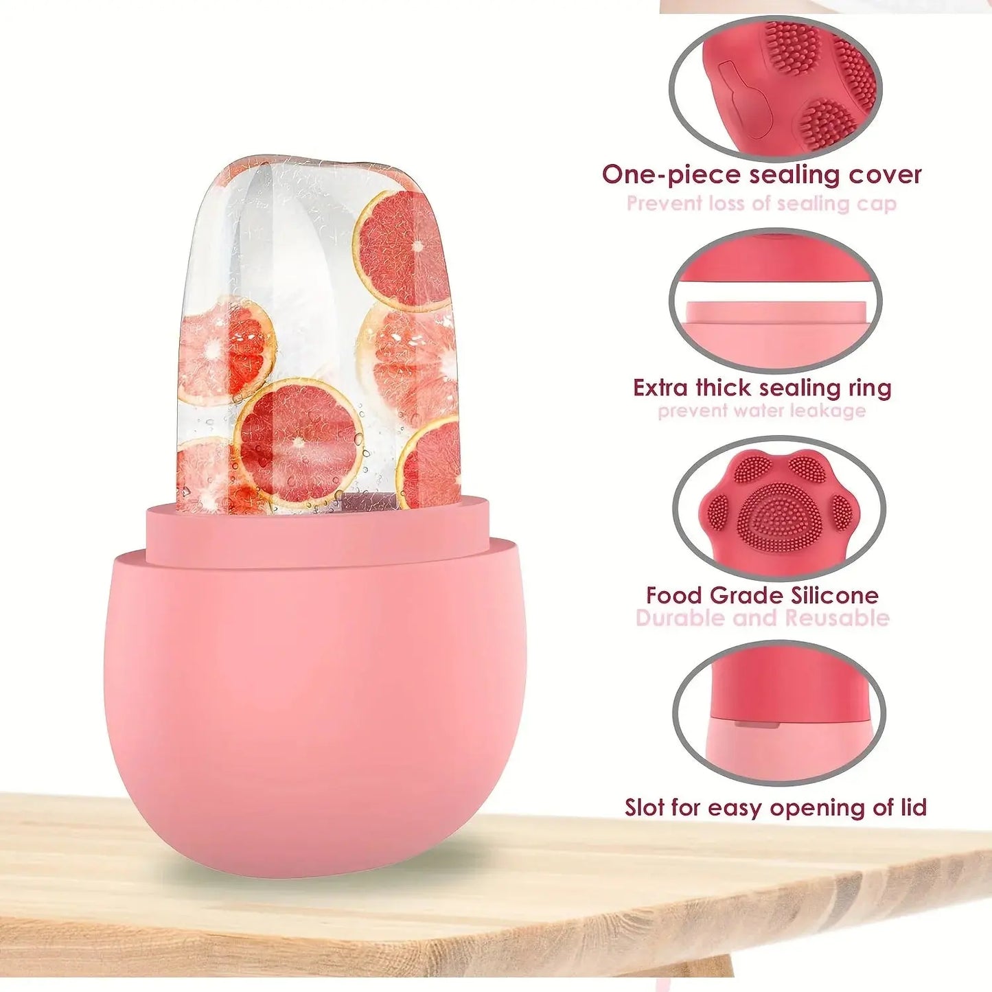 Pink silicone food storage container with grapefruit design on a wooden surface