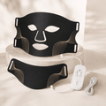 Black premium LED face and neck mask set with gold accents, remote control, and charging cable