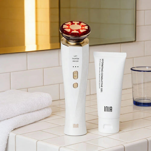 Beauty device and INIA skincare product on a bathroom counter